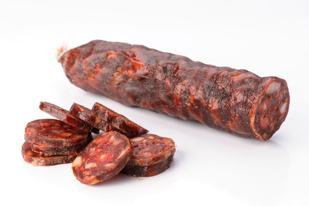 55735512 - iberian sausage cut isolated on white