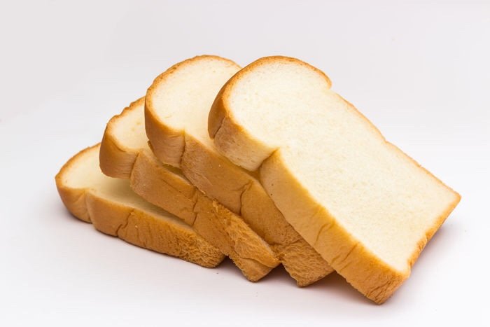 32446657 - slice of bread on white background